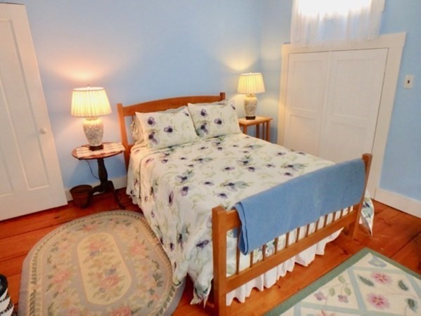 12 Cottle Lane Edgartown, MA 02539 - Photo 14 of 29 a bed sitting in a bedroom next to a window with lamp
