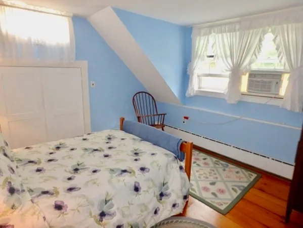 a bedroom with a bed dresser and a window