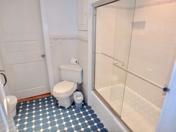a bathroom with a toilet and a shower