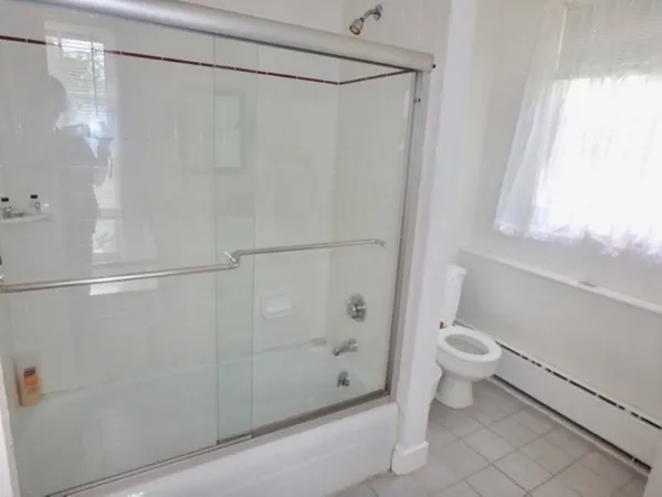a bathroom with a shower and a toilet