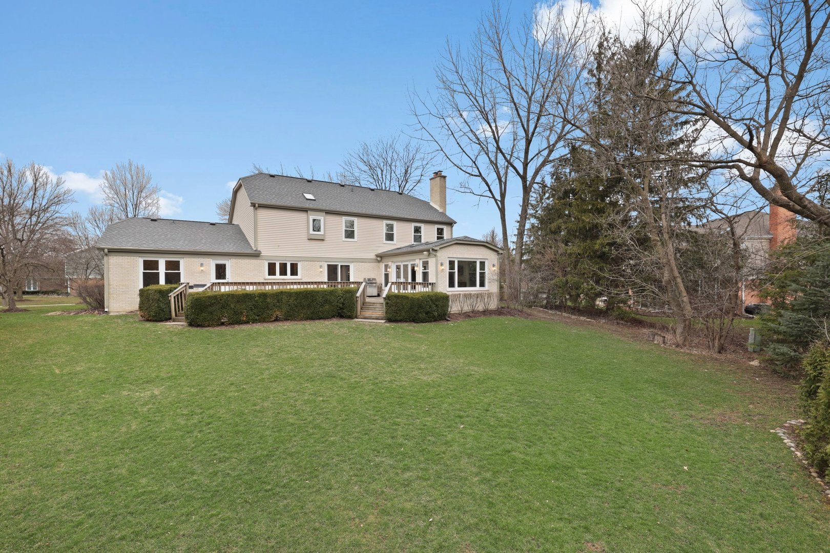 235 Covington Drive Barrington, IL 60010 - Photo 29 of 33 a front view of a house with a garden and trees