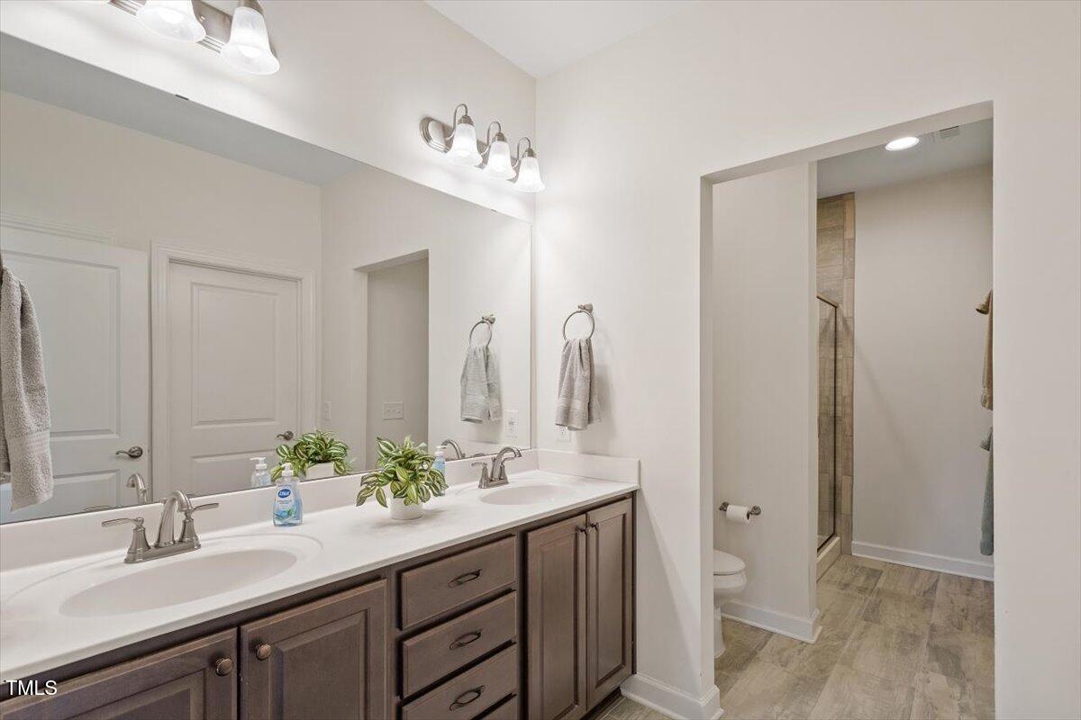 1357 Prevenient Drive Wake Forest, NC 27587 - Photo 33 of 58 a spacious bathroom with a double vanity sink mirror and a
