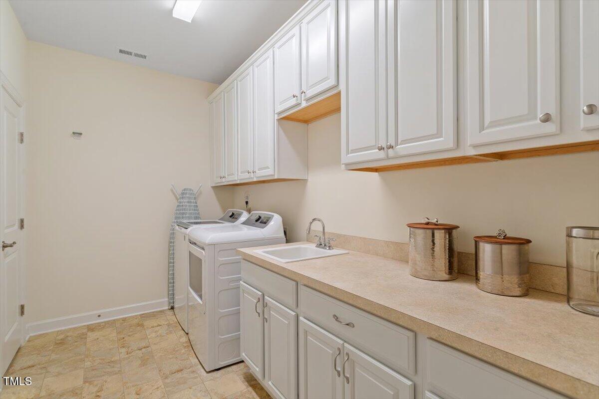 1357 Prevenient Drive Wake Forest, NC 27587 - Photo 44 of 58 a kitchen with a sink and cabinets