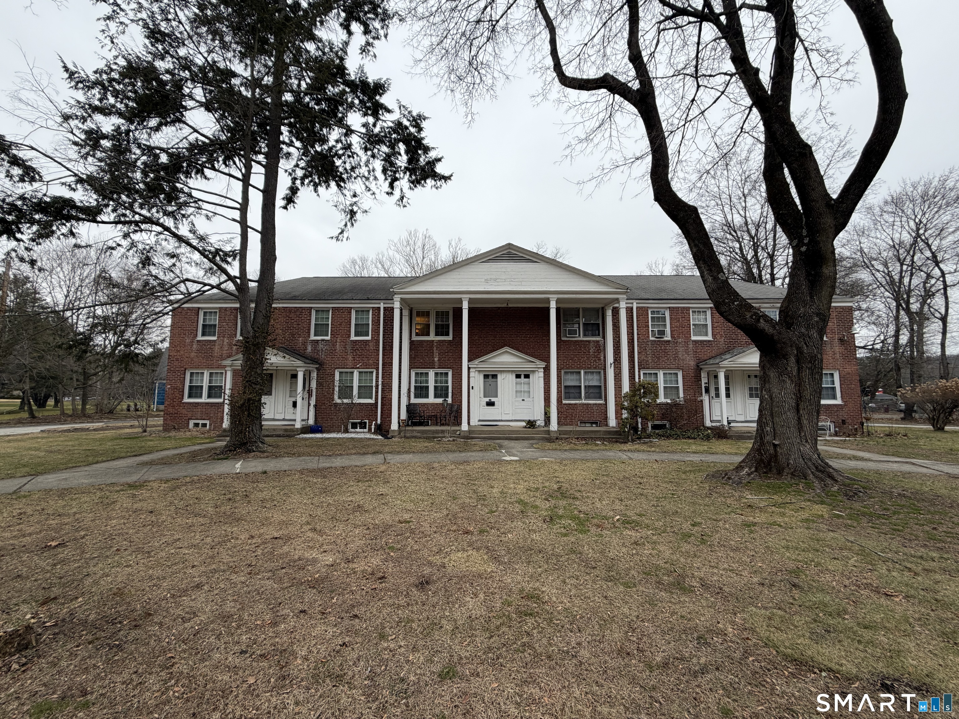 18 Bridge Street, Unit 2C Naugatuck, CT 06770 - Photo 1 of 23 a front view of a house with garden