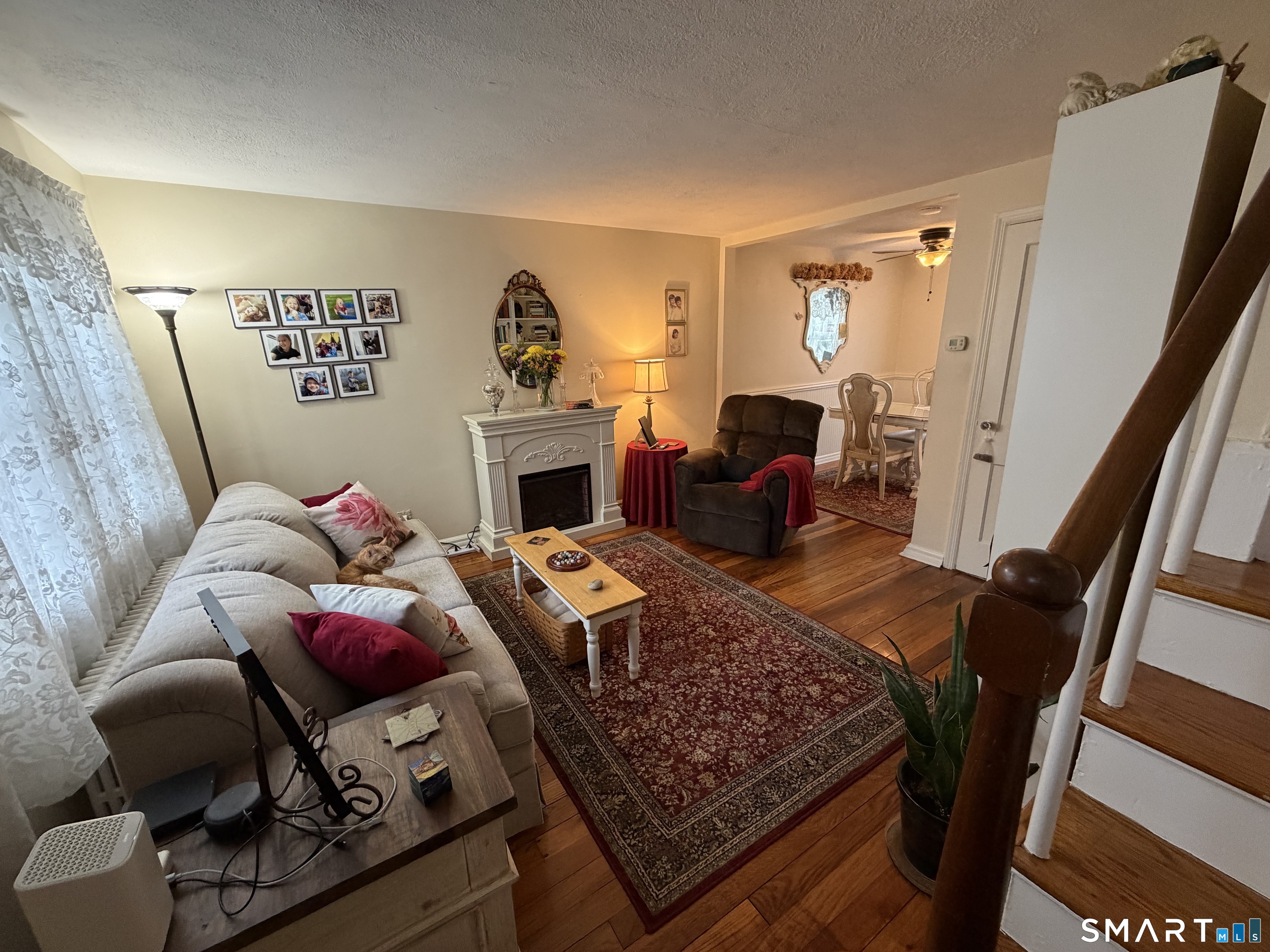18 Bridge Street, Unit 2C Naugatuck, CT 06770 - Photo 2 of 23 a living room with furniture rug and a fireplace