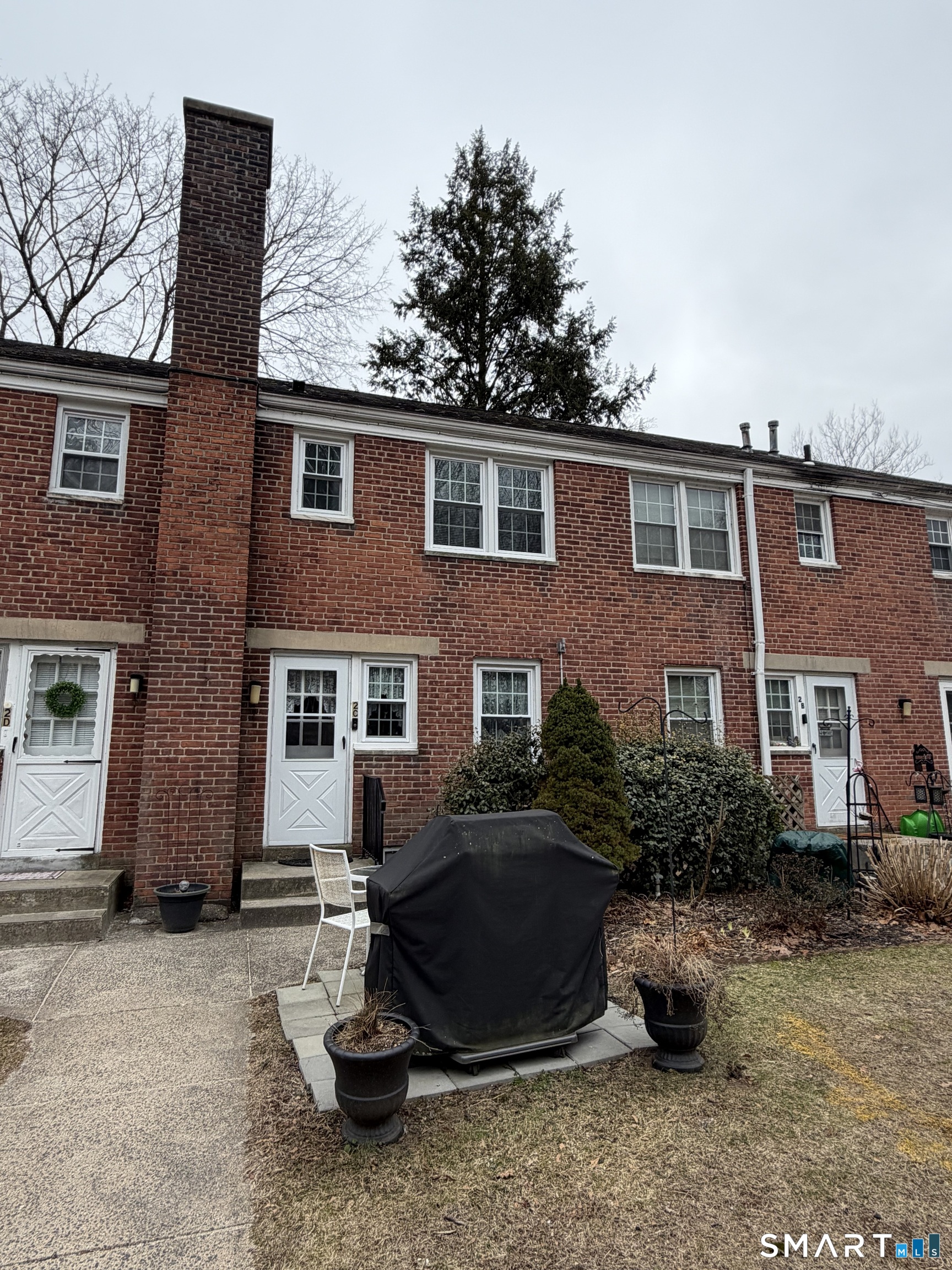 18 Bridge Street, Unit 2C Naugatuck, CT 06770 - Photo 21 of 23 a backyard of a house with a yard and barbeque oven