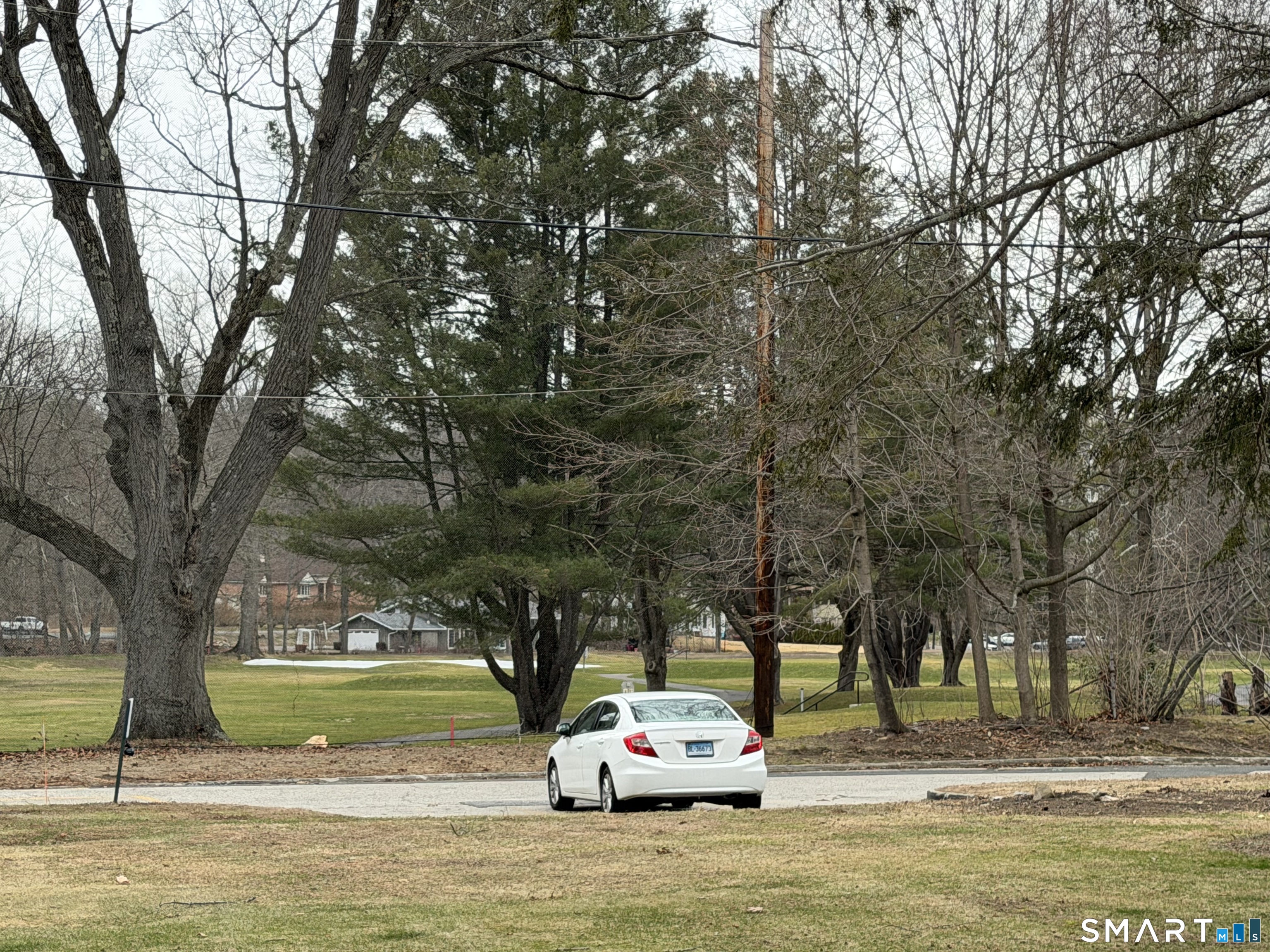 18 Bridge Street, Unit 2C Naugatuck, CT 06770 - Photo 23 of 23 a white house that has a tree in front of it