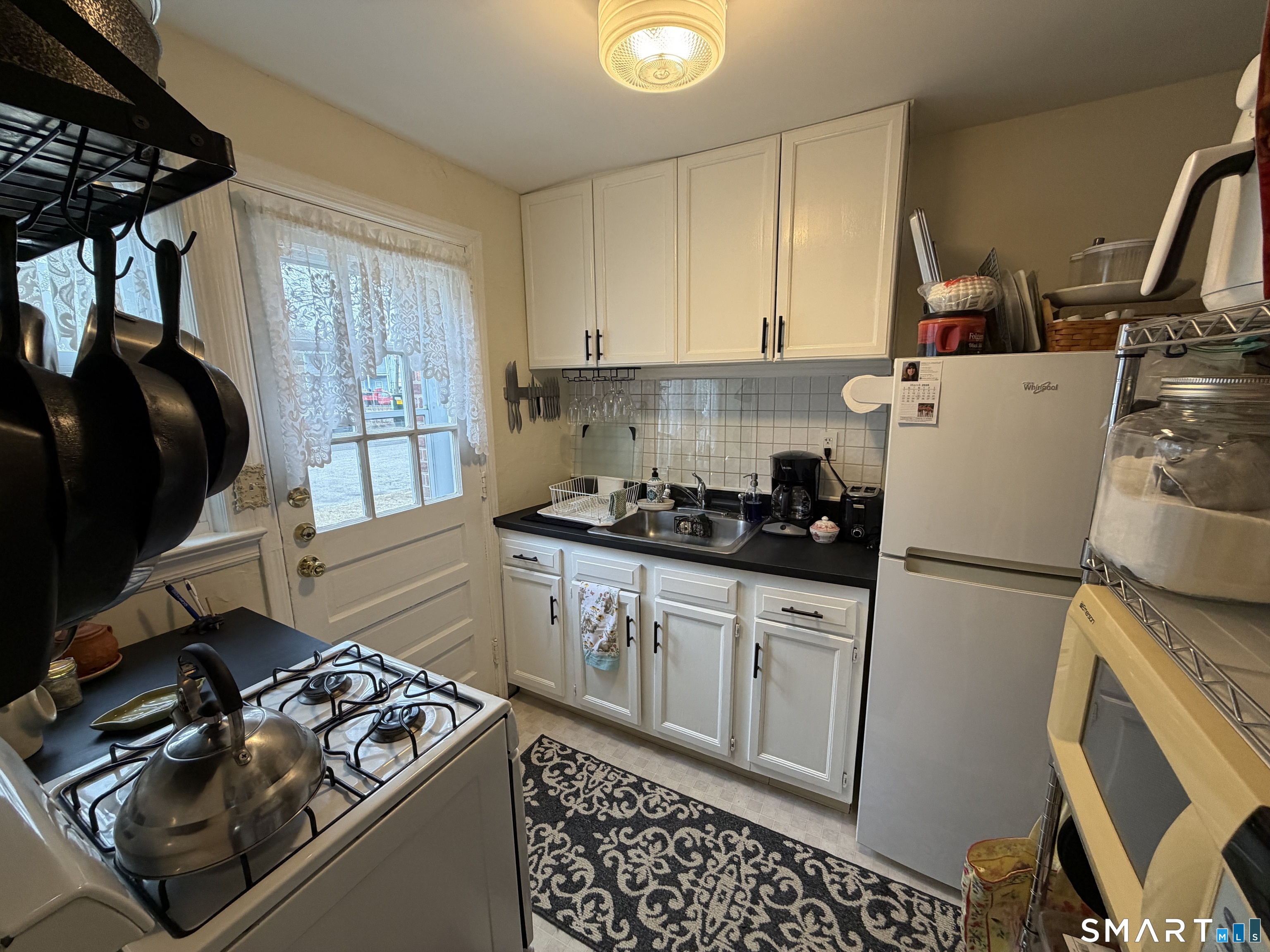 18 Bridge Street, Unit 2C Naugatuck, CT 06770 - Photo 5 of 23 a kitchen with a refrigerator stove and sink