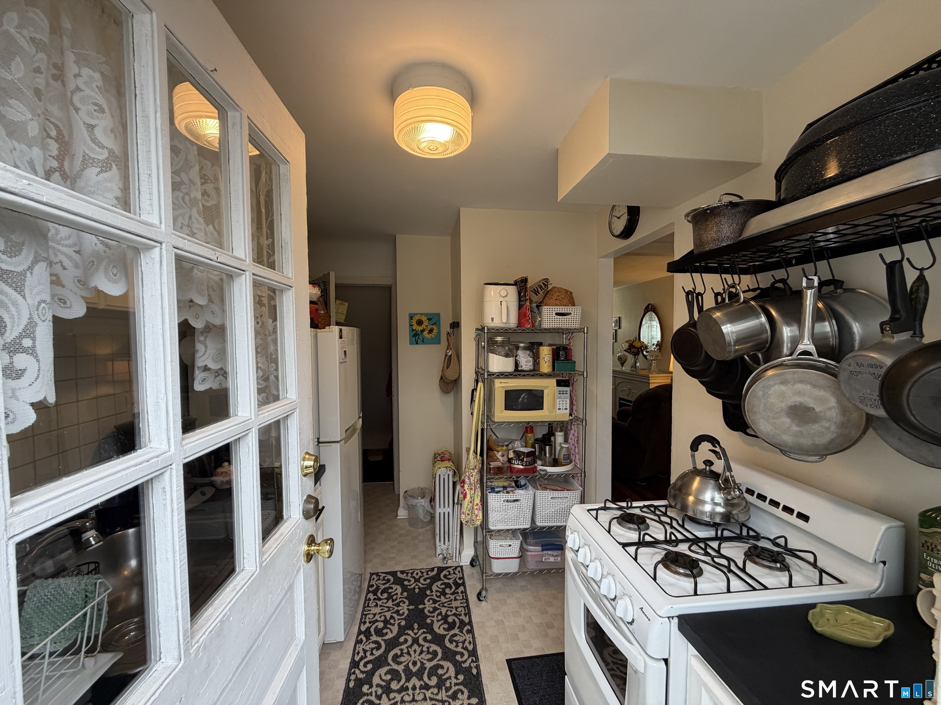 18 Bridge Street, Unit 2C Naugatuck, CT 06770 - Photo 6 of 23 a kitchen with stainless steel appliances granite countertop a stove and a microwave