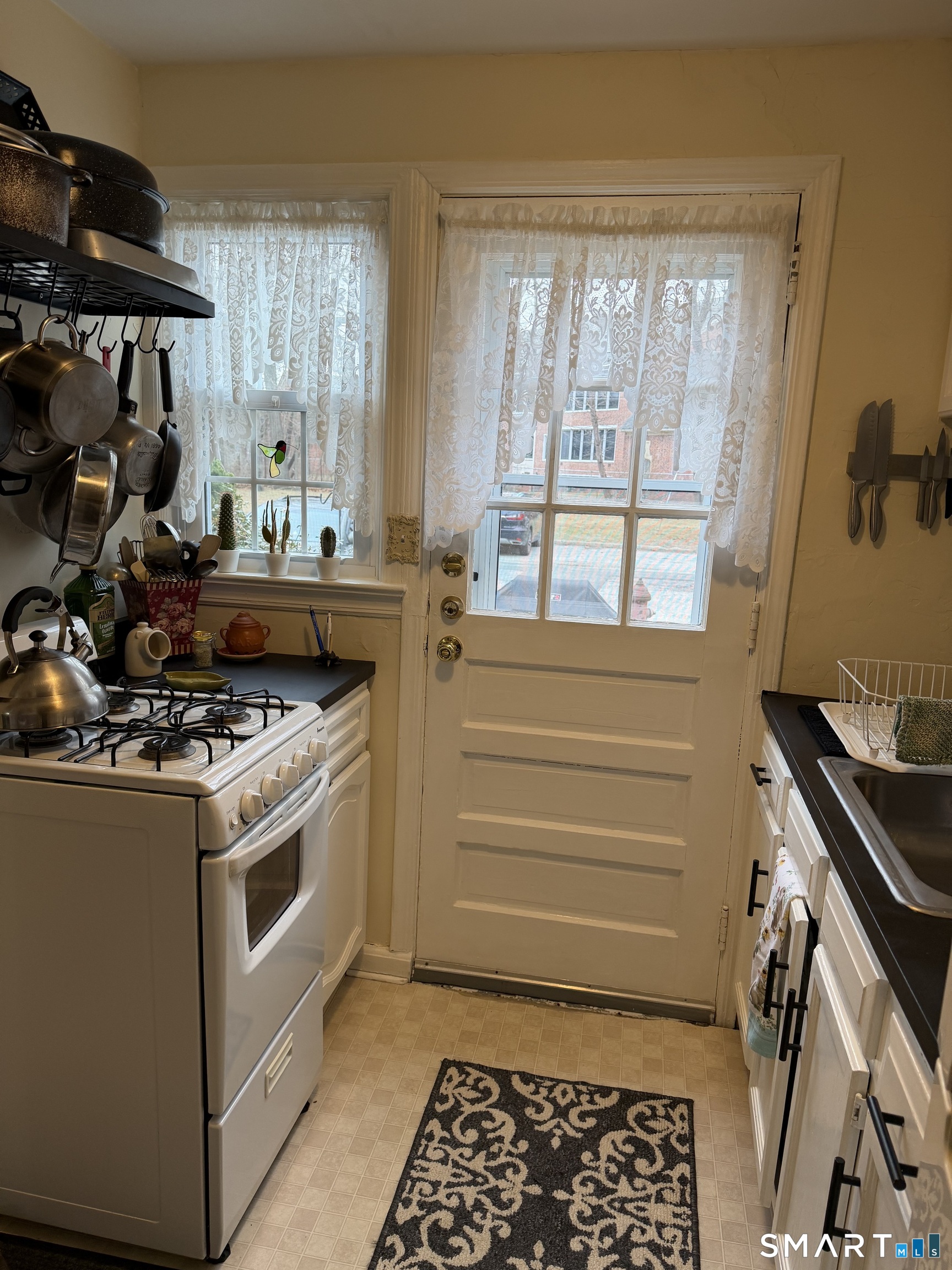 18 Bridge Street, Unit 2C Naugatuck, CT 06770 - Photo 7 of 23 a kitchen with a stove and a sink