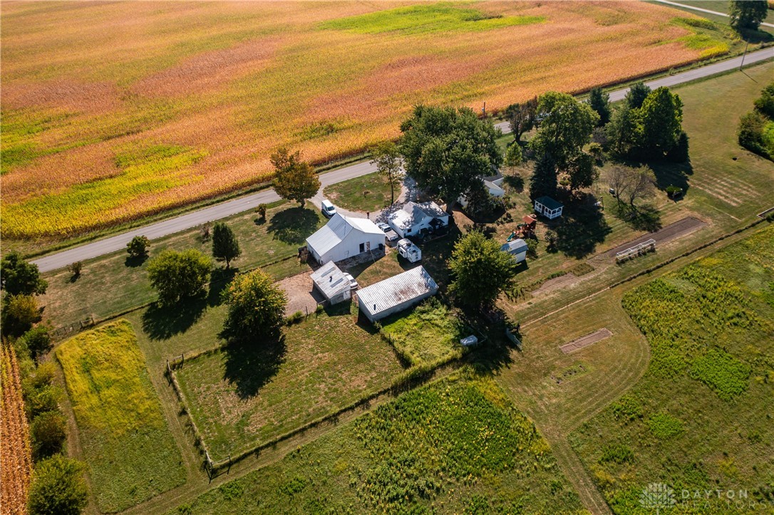 1599 Garringer Road Jamestown, OH 45335 - Photo 70 of 73 Expansive rural property featuring multiple structures amidst vibrant agricultural fields.