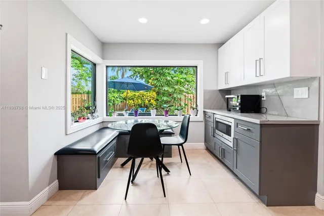 a kitchen with stainless steel appliances granite countertop a stove a sink a microwave and a refrigerator