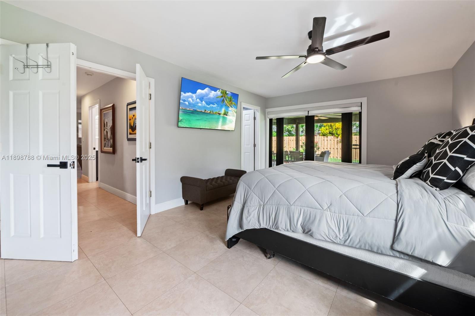 11471 Southwest 105th Terrace Miami, FL 33176 - Photo 13 of 41 a spacious bedroom with a bed and a chandelier