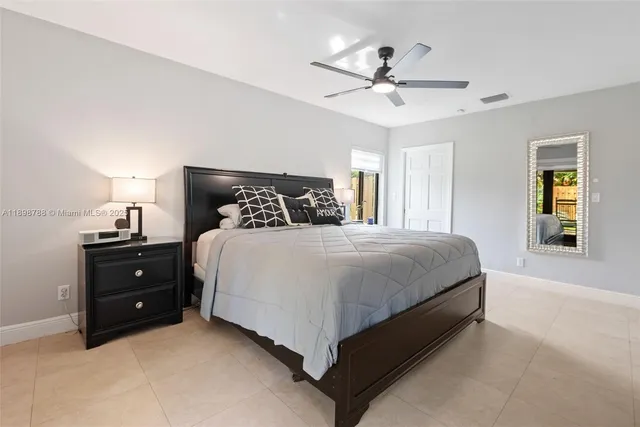 a bed room with a bed and a chandelier