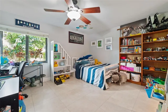 a bedroom with bed and a book shelf