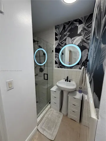 a bathroom with a sink mirror toilet and vanity