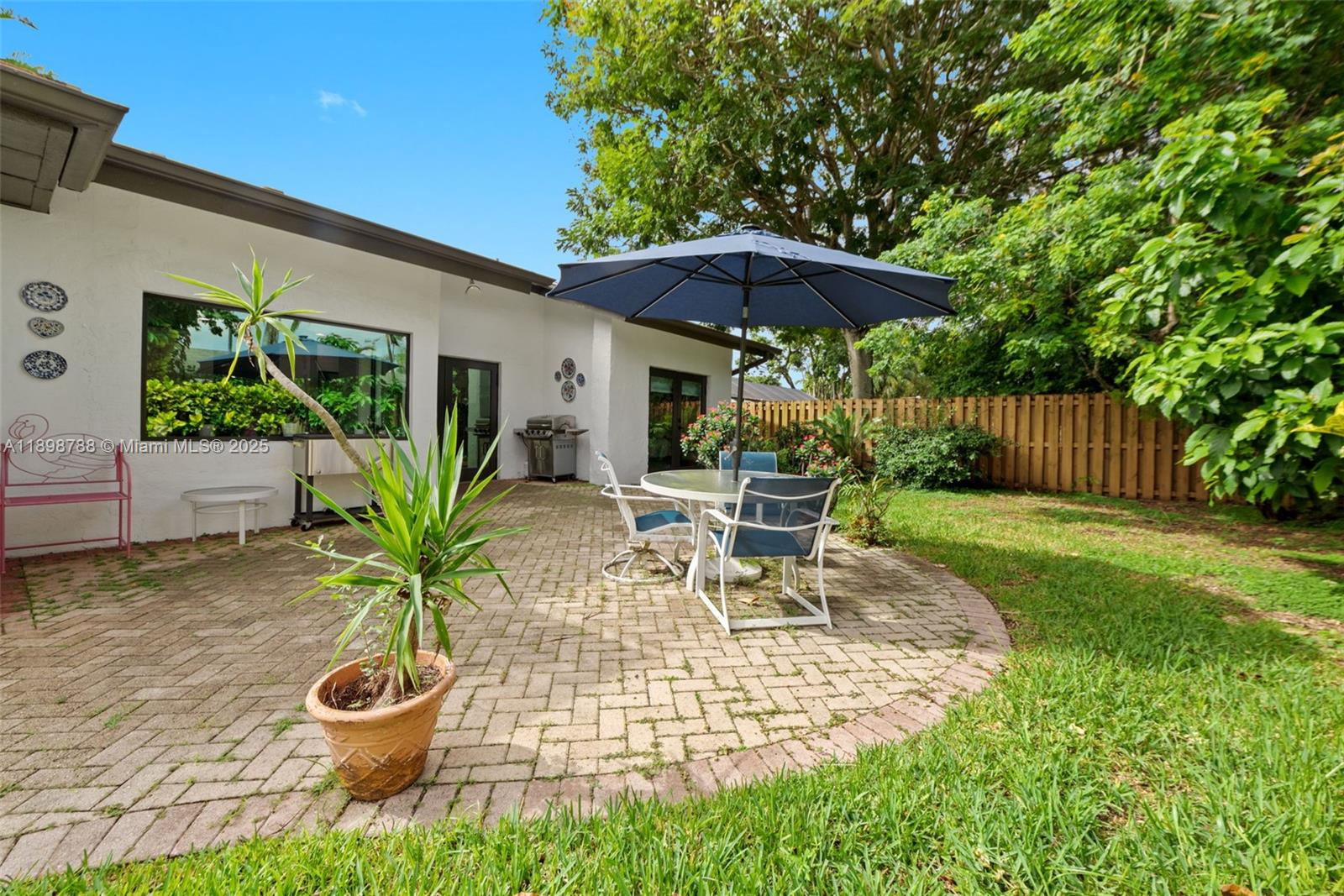 11471 Southwest 105th Terrace Miami, FL 33176 - Photo 28 of 41 a view of a chair and table in backyard of the house