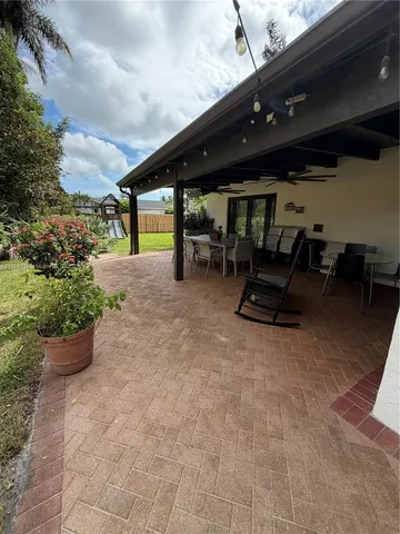 a swimming pool with outdoor seating and yard