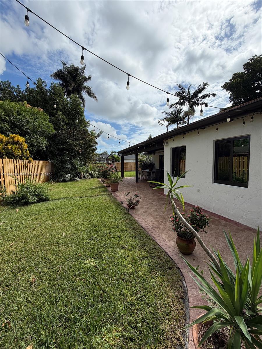 11471 Southwest 105th Terrace Miami, FL 33176 - Photo 32 of 41 a backyard of a house with table and chairs