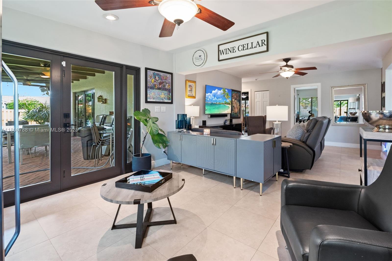 11471 Southwest 105th Terrace Miami, FL 33176 - Photo 7 of 41 a living room with furniture a flat screen tv and a large window