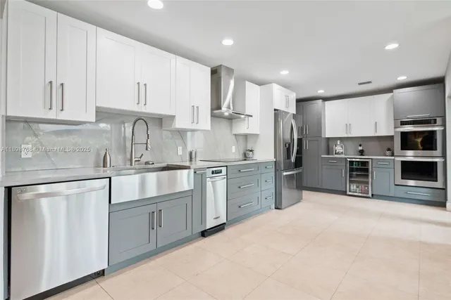 a kitchen with stainless steel appliances granite countertop a sink and cabinets