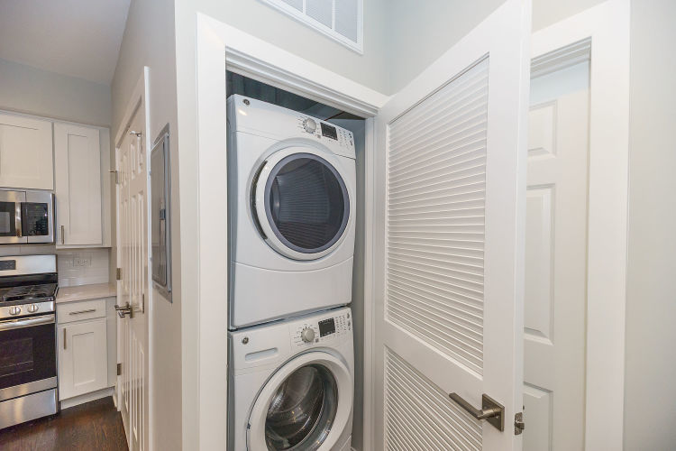 1915 West Irving Park Road, Unit 303 Chicago, IL 60613 - Photo 8 of 14 a view of a hallway with washer and dryer