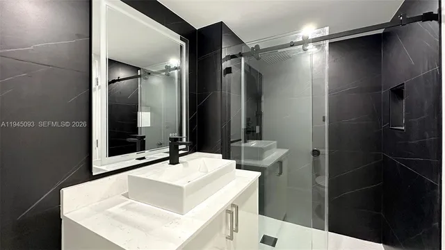 a bathroom with a sink double vanity and a mirror