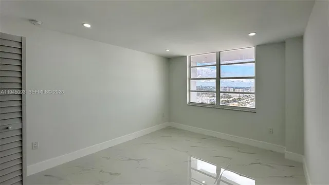 a view of an empty room with a window