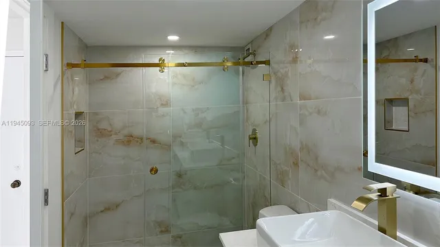 a bathroom with a shower and a toilet sink