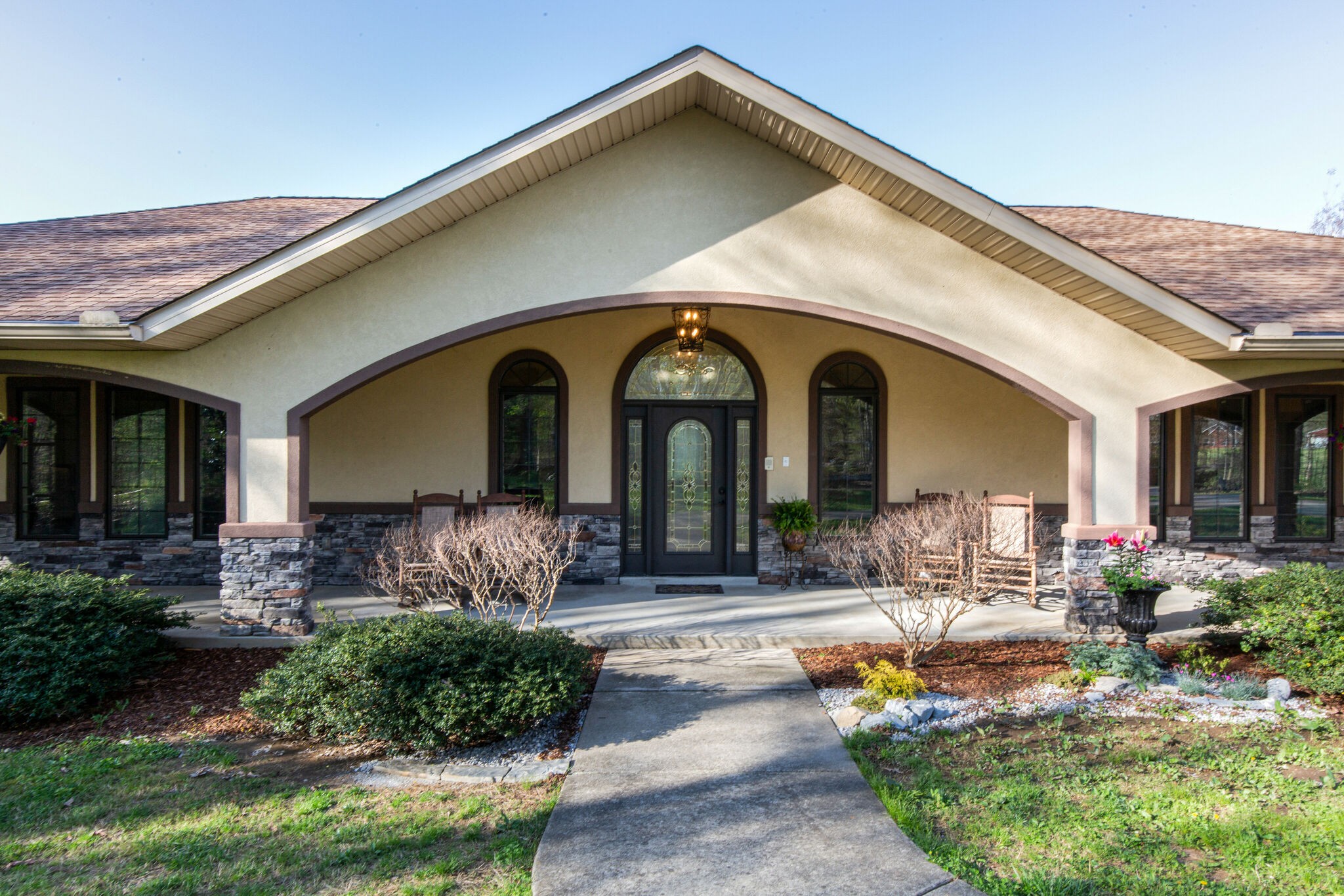 a front view of a house with garden
