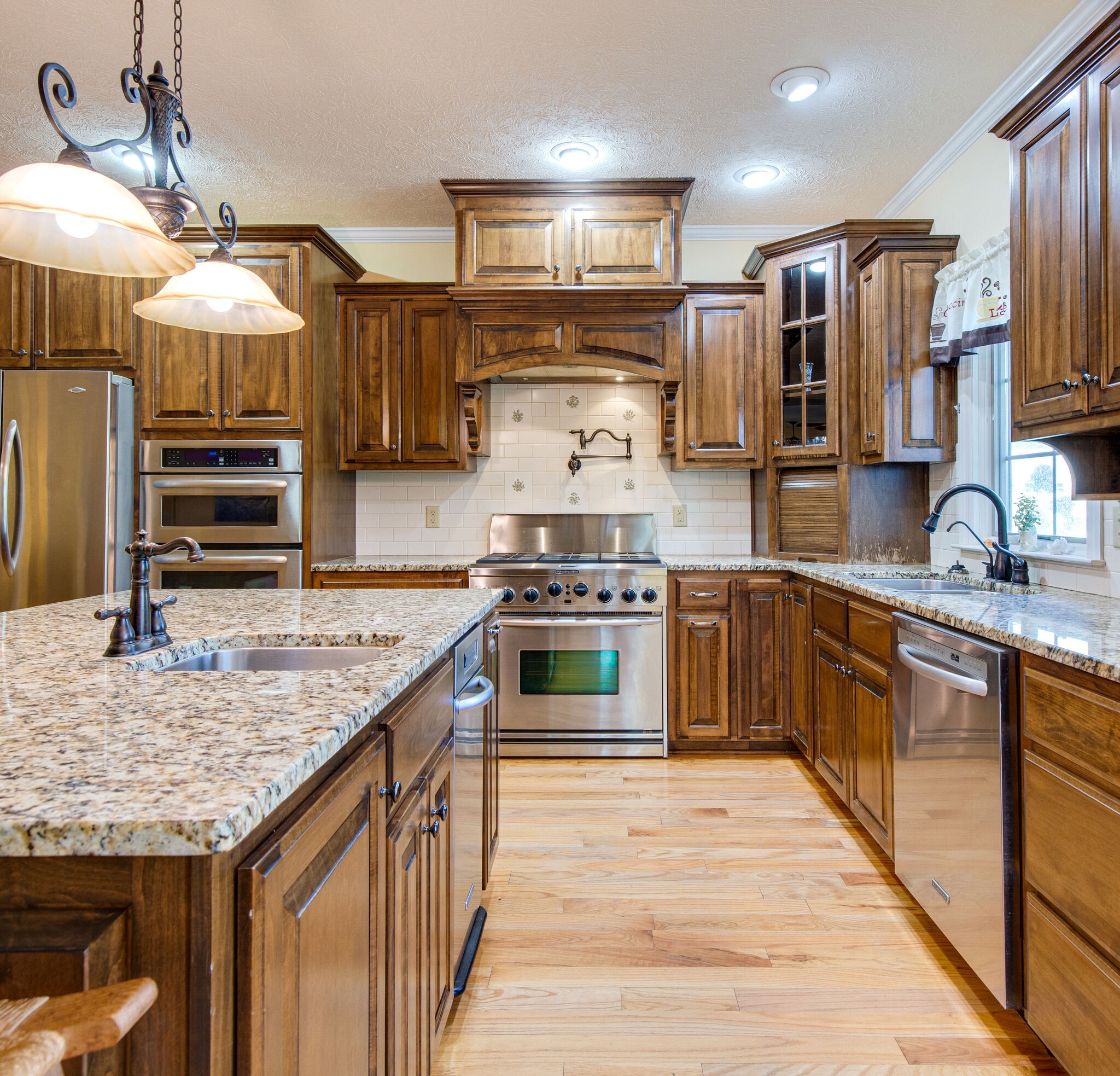 143 Sycamore Road Dickson, TN 37055 - Photo 15 of 36 a kitchen with stainless steel appliances granite countertop a stove a sink and a refrigerator