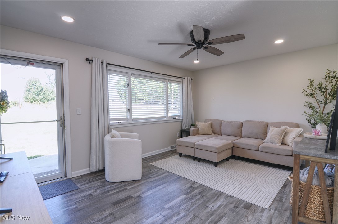 7777 Ridge Road Wadsworth, OH 44281 - Photo 3 of 30 Living room featuring ceiling fan, dark hardwood / wood-style floors, and a healthy amount of sunlight
