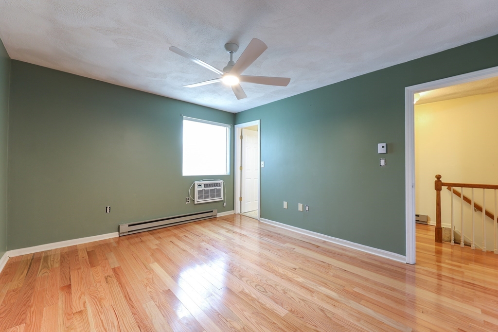 6 Erick Road, Unit 73 Mansfield, MA 02048 - Photo 17 of 21 an empty room with wooden floor fan and windows