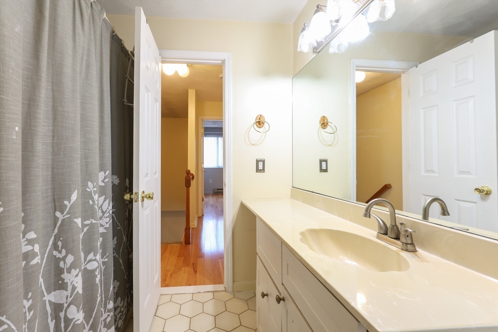 6 Erick Road, Unit 73 Mansfield, MA 02048 - Photo 18 of 21 a bathroom with a granite countertop sink and a mirror