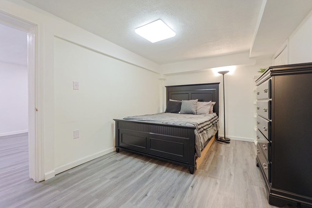 6 Erick Road, Unit 73 Mansfield, MA 02048 - Photo 19 of 21 a room with a bed and a flat screen tv