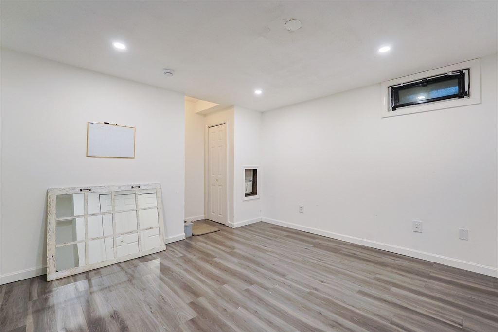 6 Erick Road, Unit 73 Mansfield, MA 02048 - Photo 21 of 21 an empty room with wooden floor and windows