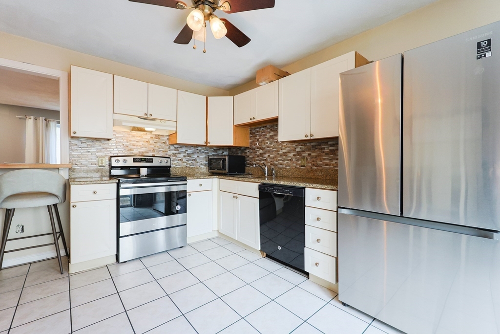 6 Erick Road, Unit 73 Mansfield, MA 02048 - Photo 9 of 21 a kitchen with stainless steel appliances a refrigerator sink and microwave
