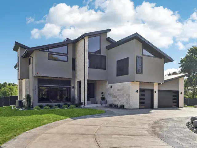 a front view of a house with a garden and entryway