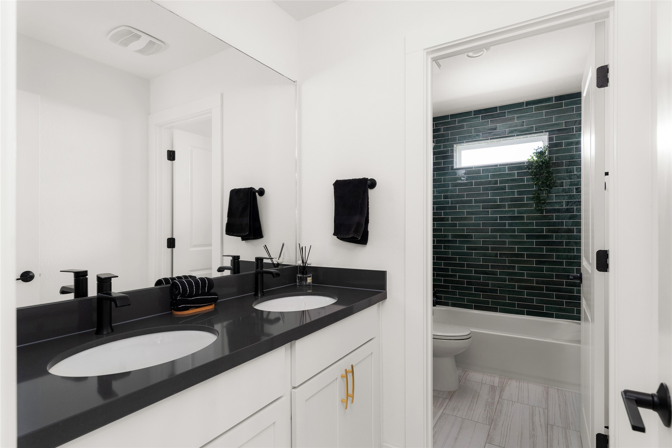 7917 Edmondson Bend Austin, TX 78744 - Photo 13 of 24 Bathroom featuring a dual vanity with dark countertops and white cabinetry