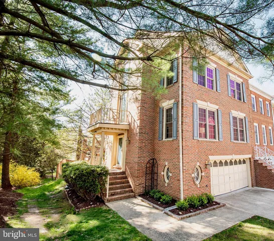 a front view of a house with a yard and potted plants