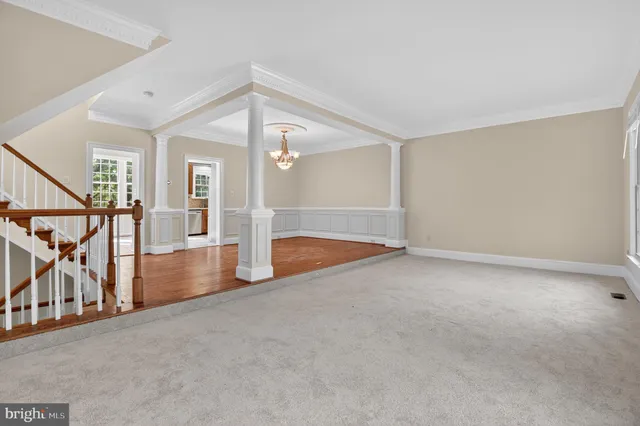 a view of staircase with wooden floor and white walls