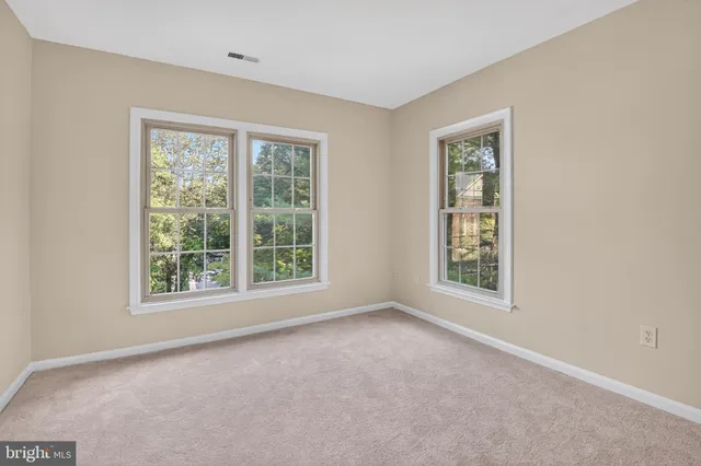 a view of a hallway with wooden floor and stairs