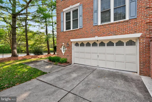 a view of a house with a yard and potted plants