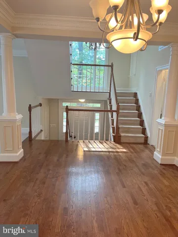 a view of an empty room with stairs and a fireplace