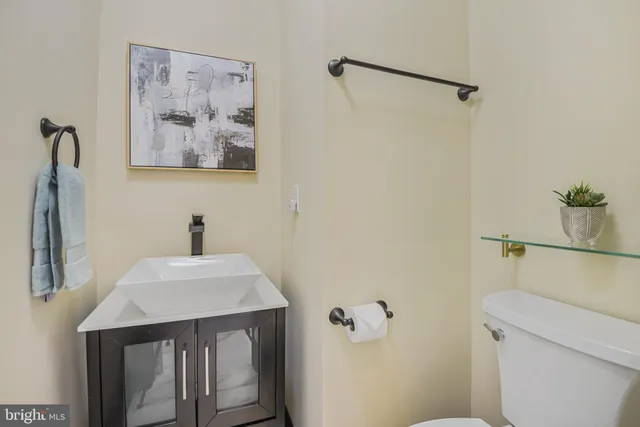 a bathroom with a sink and mirror with toilet