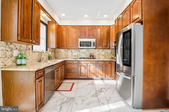 a kitchen with a refrigerator and cabinets