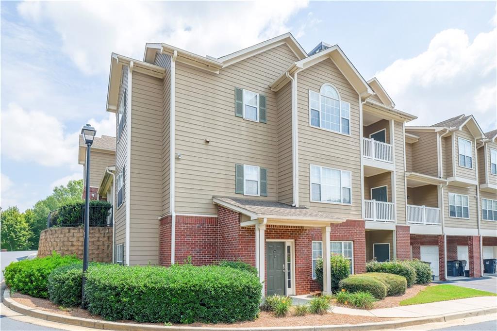 3500 Sweetwater Road, Unit 102 Duluth, GA 30096 - Photo 1 of 1 a front view of a house with a yard