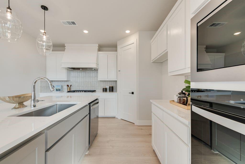 12703 Pine Ridge Trail Rowlett, TX 75089 - Photo 12 of 30 a kitchen with a sink stove and cabinets
