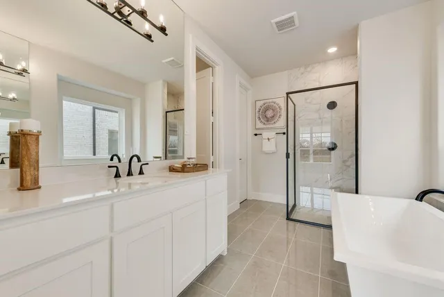 a spacious bathroom with a shower a mirror and a sink