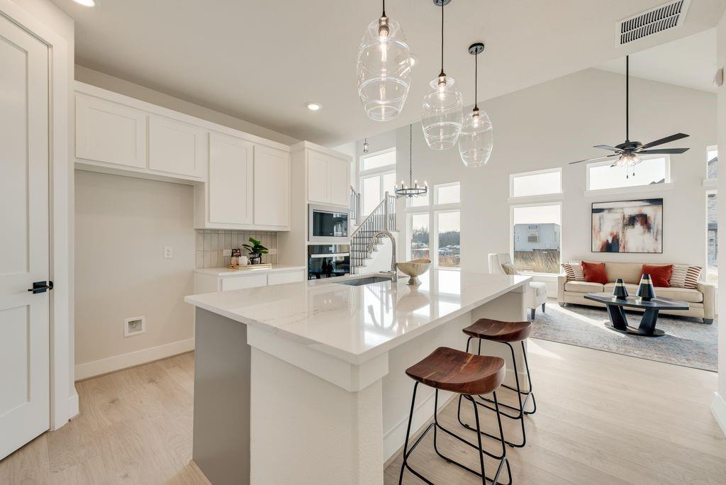 12703 Pine Ridge Trail Rowlett, TX 75089 - Photo 10 of 30 a very nice looking dining room with kitchen island stainless steel appliances furniture a chandelier and a view of kitchen